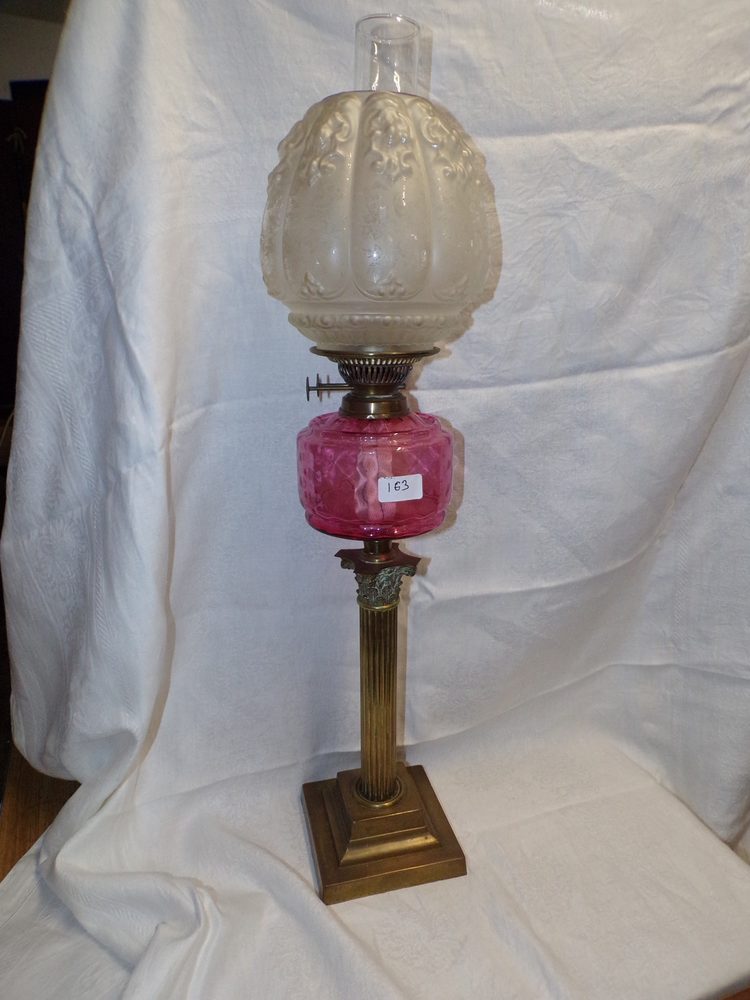 Ruby glass bowl oil lamp on Corinthian brass base