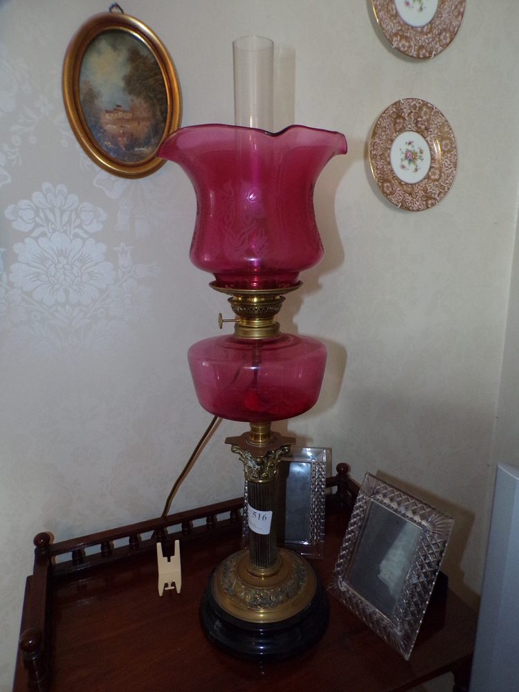 Ruby glass oil lamp on Corinthian brass pillar
